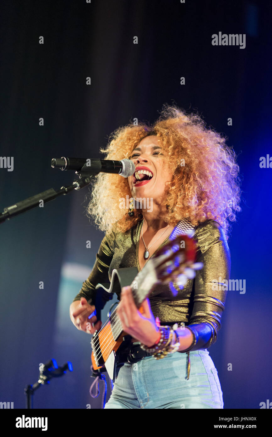 Canada, Quebec, Montreal, Montreal Jazz Festival, musicista femminile Flavia Coelho cantando e suonando chitarra sul palco Foto Stock