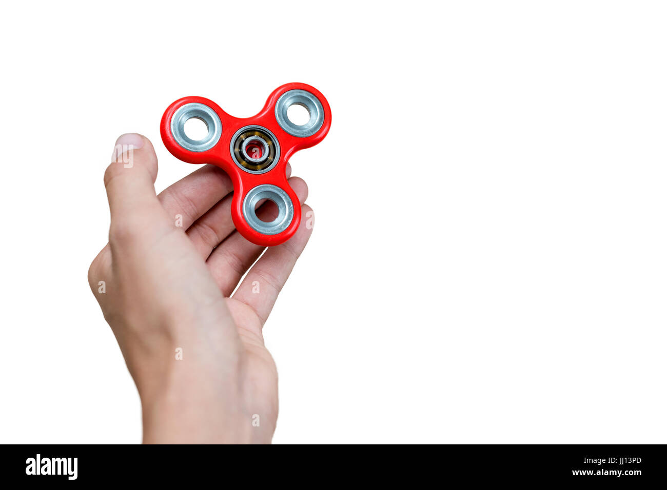 Agitano: spinner. Mano rossa spinner, agitare continuamente giocattolo a mano ruotando sul bambino la mano. Per alleviare lo stress. Anti-stress e relax adhd attenzione fad boy concetto. Spazio libero per il testo. Foto Stock