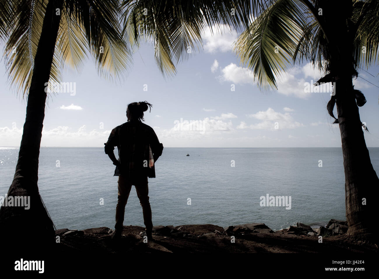 Una silhouette di un uomo che guarda la distanza sulla salvezza's islands, Guiana francese. Foto Stock