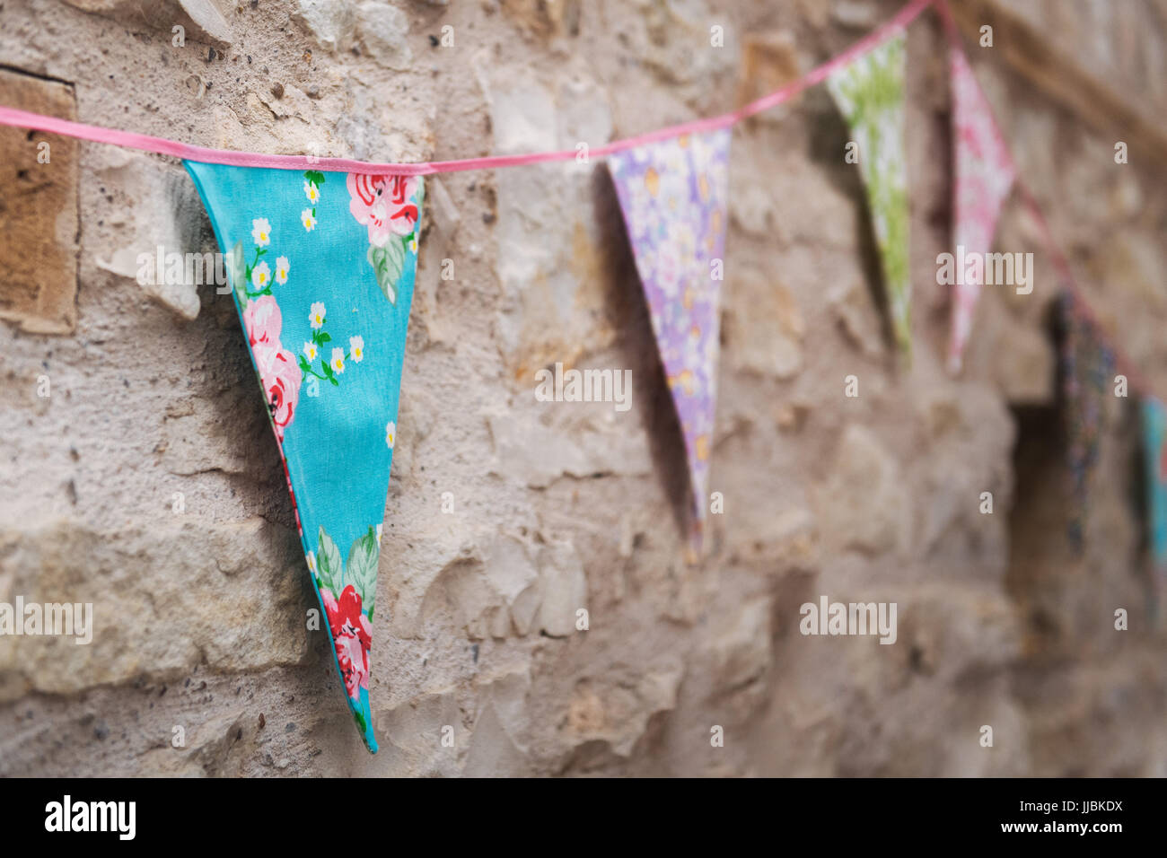 Pastello colorato bunting sulla parete di un fienile rustico ricevimento di nozze Foto Stock
