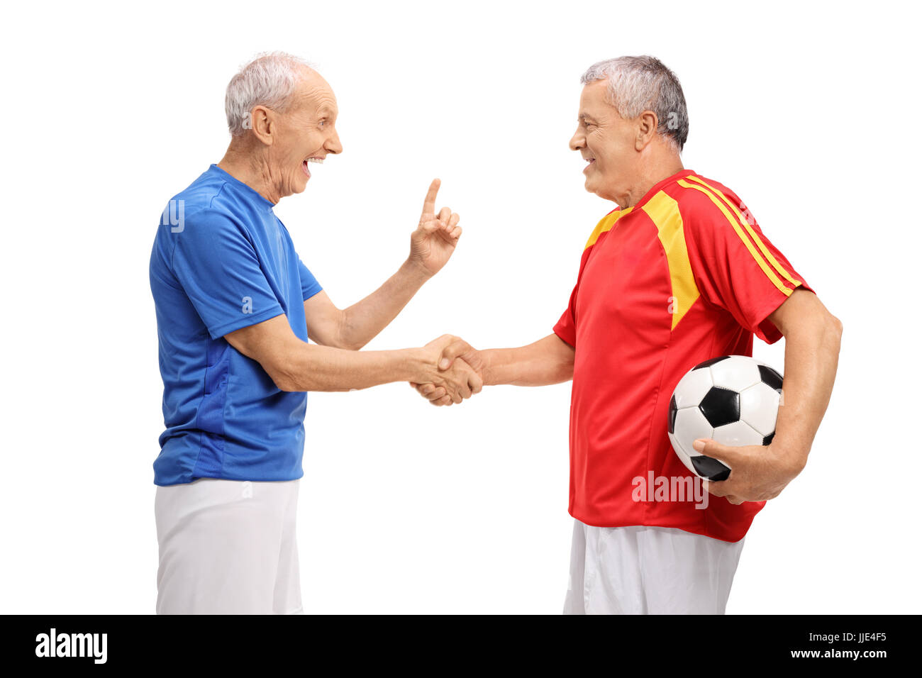 Due anziani giocatori di calcio si stringono la mano isolati su sfondo bianco Foto Stock