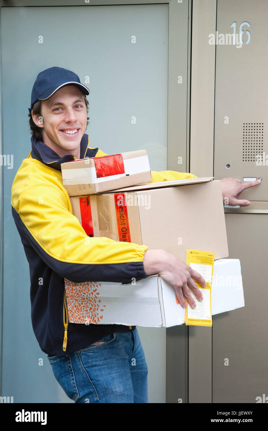Parcel deliveryman con molti pacchi Foto Stock