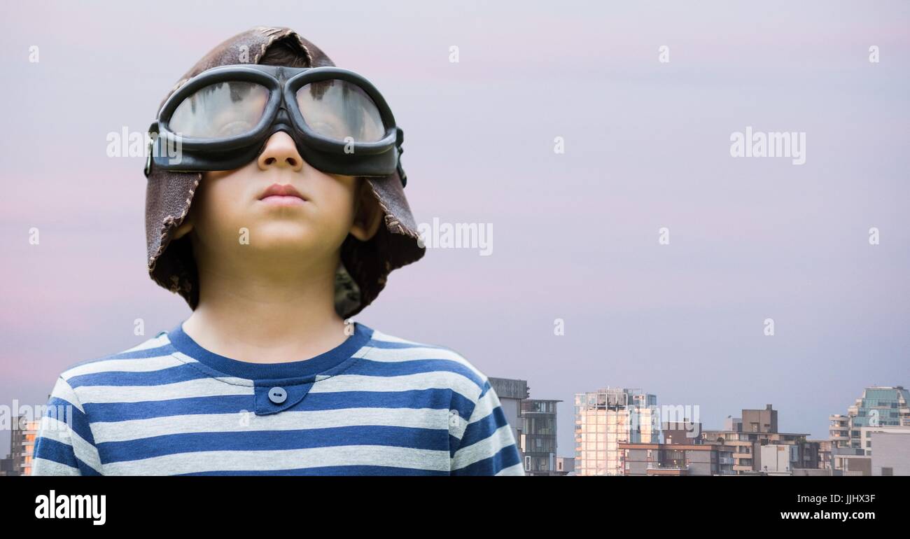 Ragazzo con gli occhiali di protezione contro edifici e del cielo della sera Foto Stock