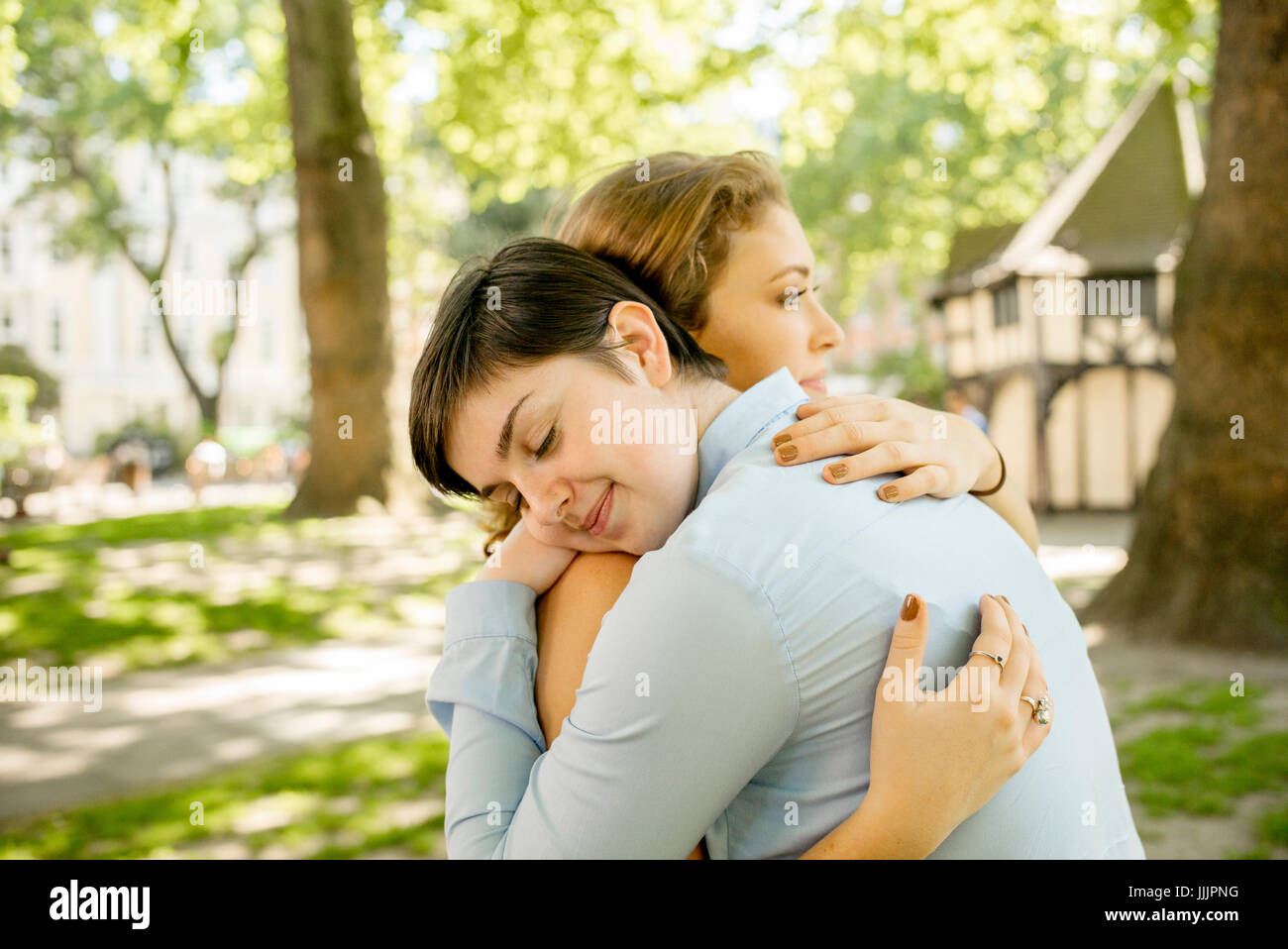 Una giovane coppia lesbica abbracciarsi nel parco. Foto Stock