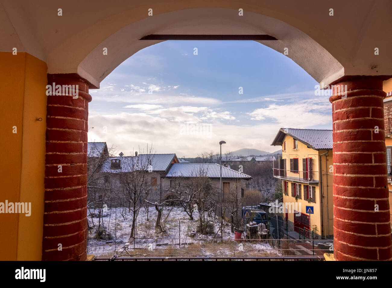 Tavigliano, Italia - 12 Gennaio 2017: un antico arco in mattoni, scena invernale con villaggi italiani sotto la neve Foto Stock