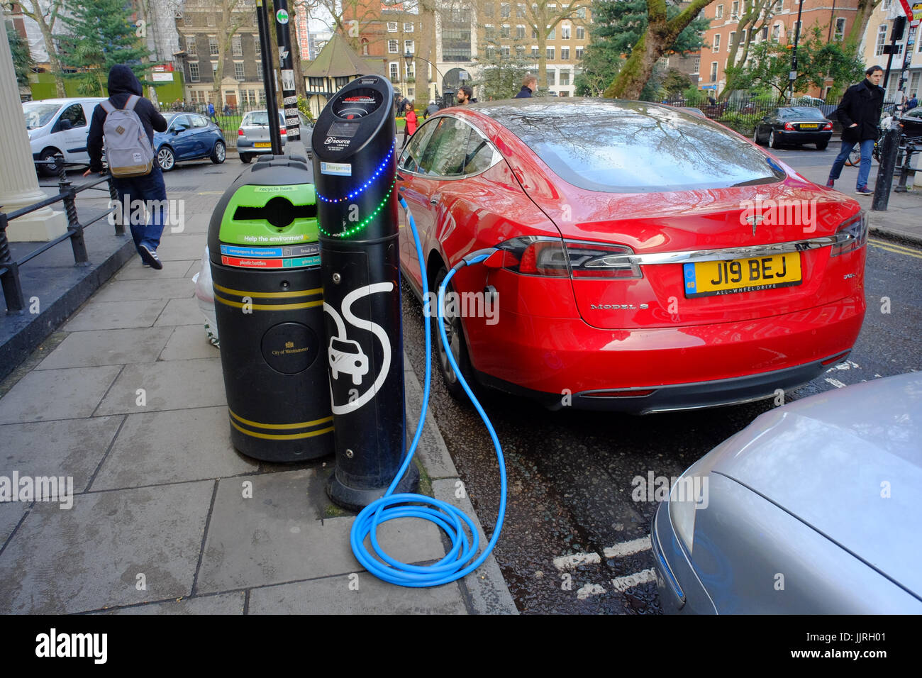 Tesla auto elettrica essendo caricato in corrispondenza di un punto di ricarica in Londra, Regno Unito Foto Stock