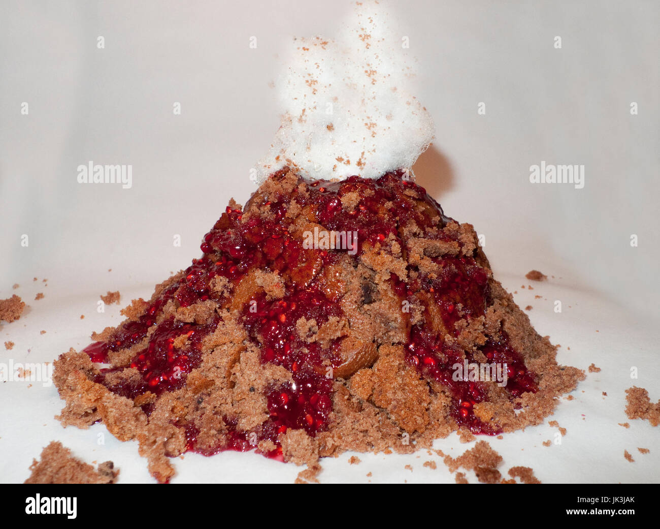Vulkan Kuchen mit Himbeer Lava Soße und Zuckerwatte Rauch Foto Stock