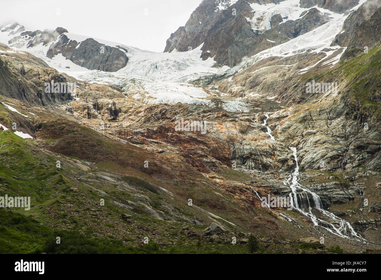 Nuvoloso coperto di ghiaccio sulle montagne delle Alpi vicino al confine italiano lungo il Tour du Mont Blanc Foto Stock