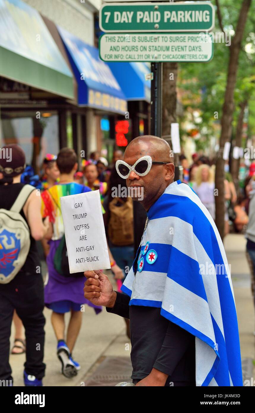 Chicago, Illinois, Stati Uniti d'America. Uomo con un messaggio politico tra parade frequentatori di atteggiamenti liberali rendendo il loro modo di Chicago's Pride Parade. Foto Stock