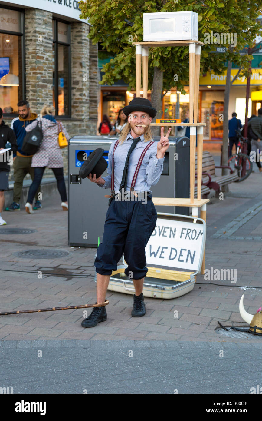Performer di strada in un cappello bowler gesticolando un segno di pace, Queenstown waterside, Nuova Zelanda Foto Stock