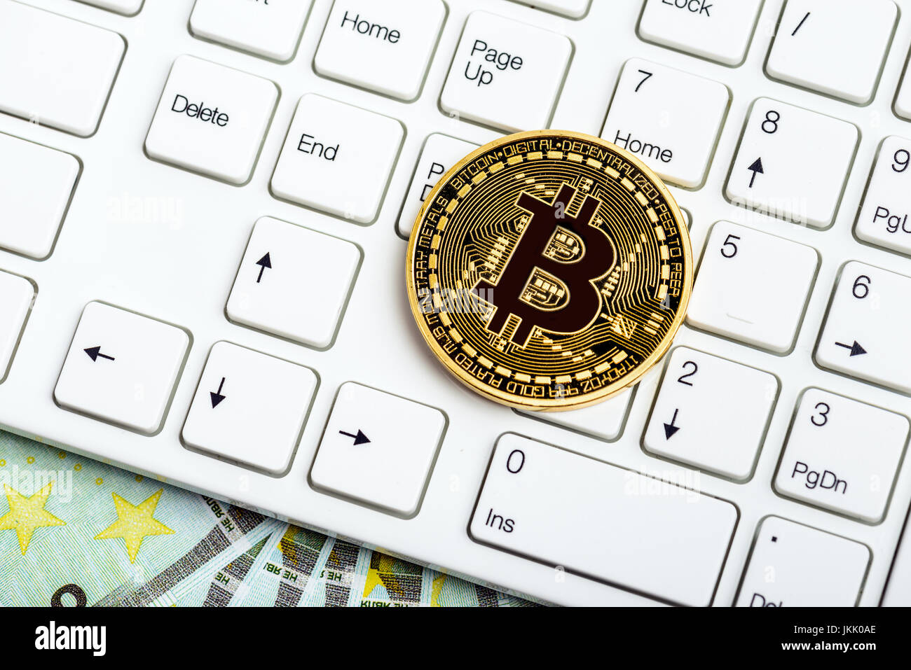 Bitcoin moneta sulla tastiera bianca e denaro Foto Stock