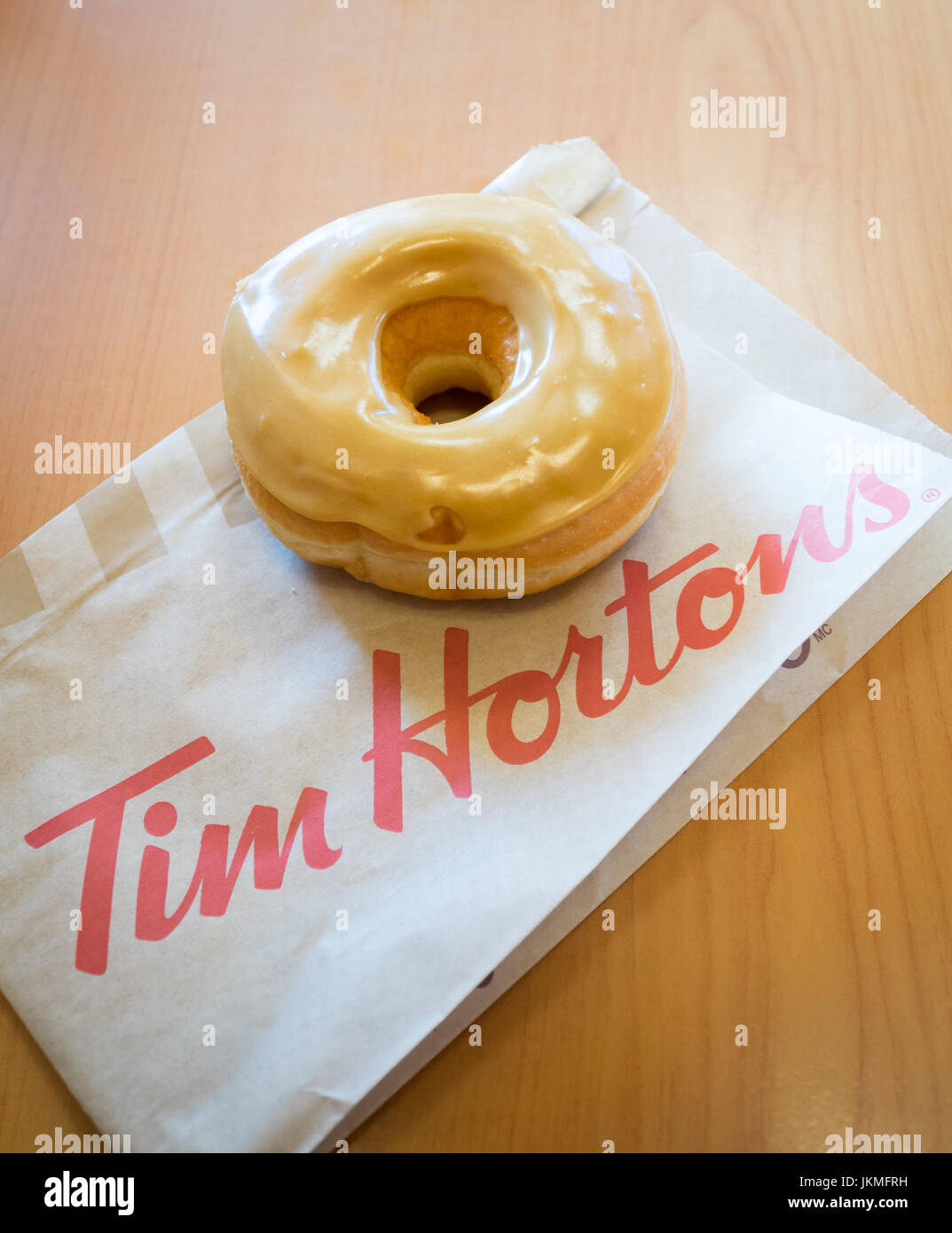 Un Tim Hortons acero ciambella dip. Foto Stock