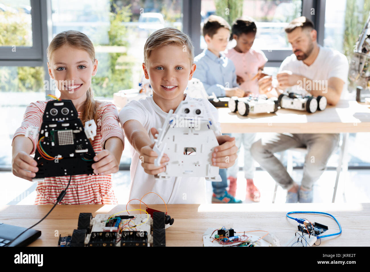 Sorella e fratello la tenuta dei loro modelli di robot Foto Stock