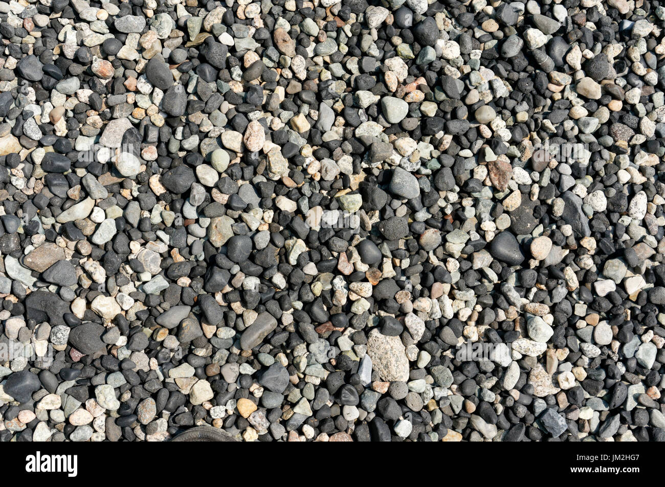 Close-up di variopinte arrotondati ciottoli di spiaggia su una spiaggia rocciosa sull isola di Bowen, British Columbia, Canada Foto Stock