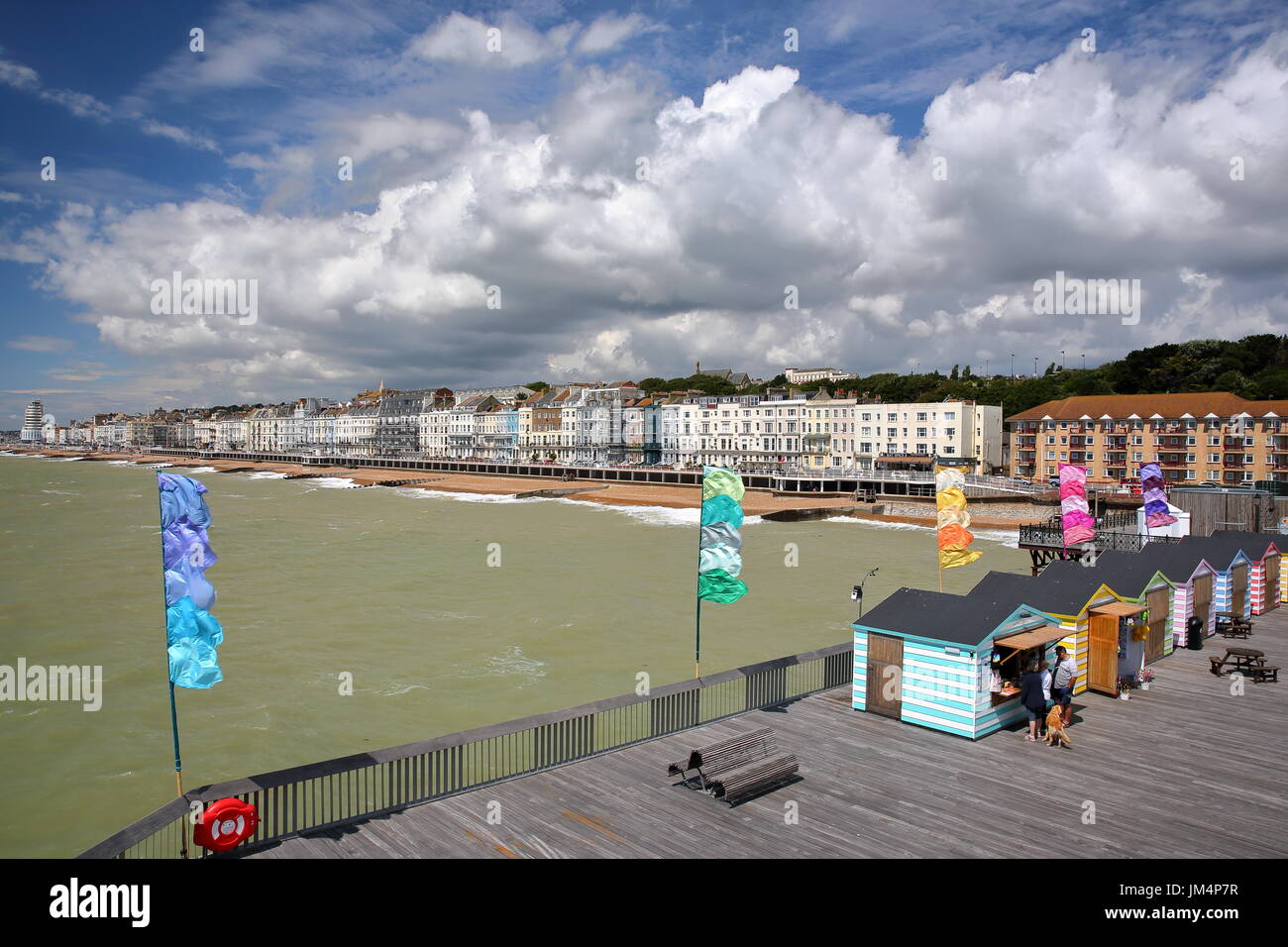 HASTINGS, Regno Unito - Luglio 23, 2017: vista del mare dal molo (ricostruita e aperta al pubblico nel 2016) con capanne colorate in primo piano e un beaut Foto Stock