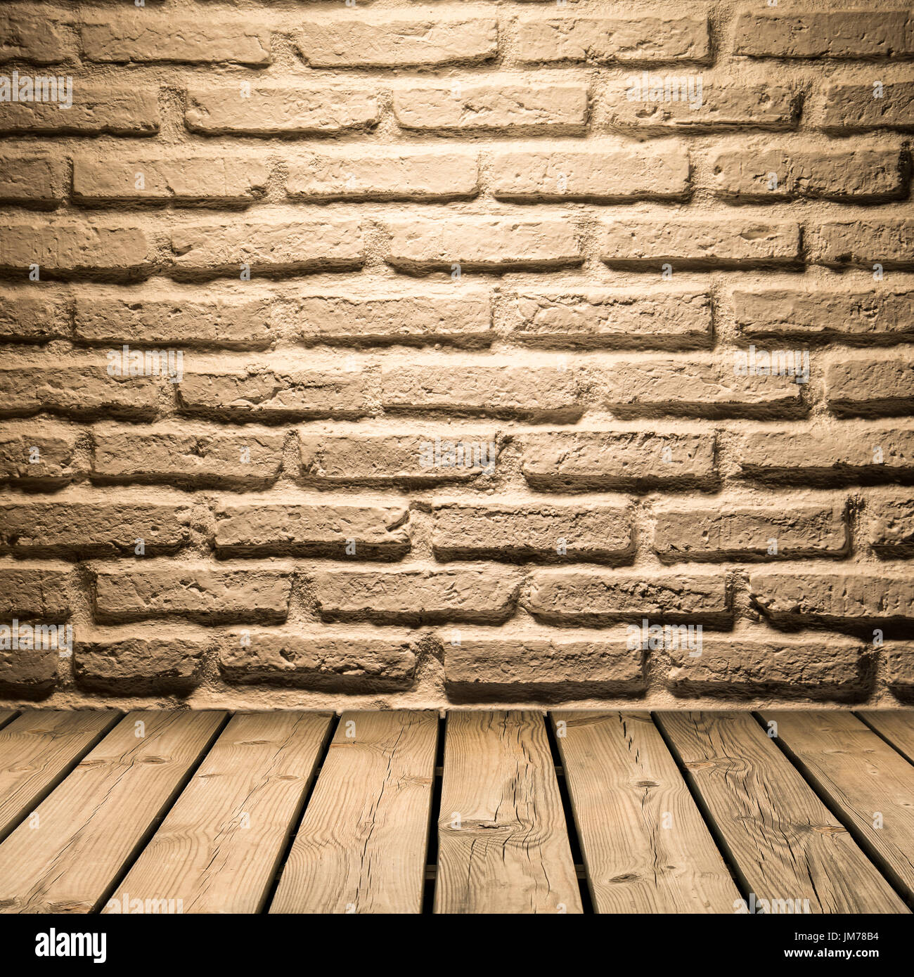 In mattoni bianchi sullo sfondo della parete sul pavimento in legno Foto Stock