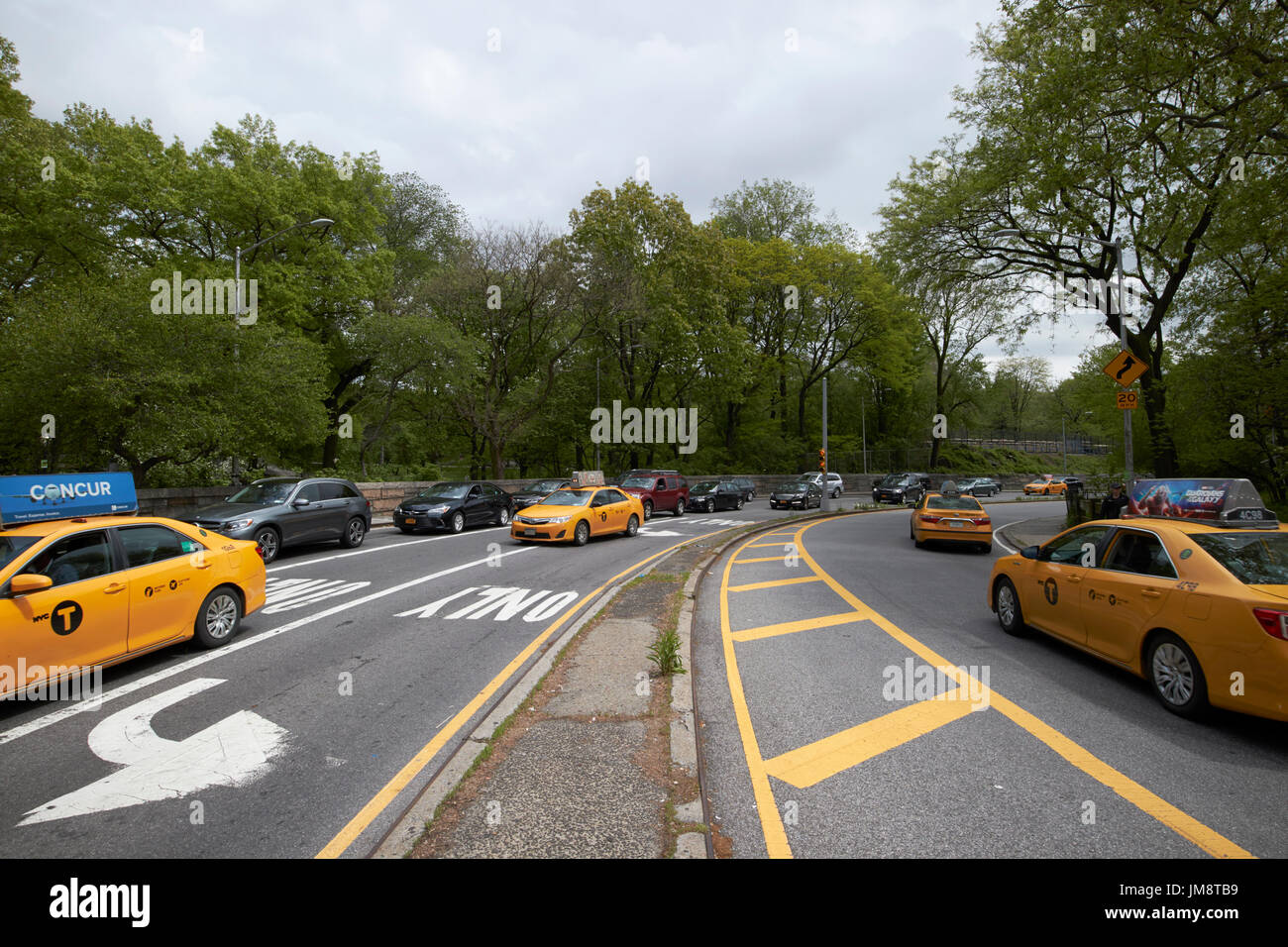 Cabine e vetture di traffico sulla strada trasversale attraverso il Central Park di New York City STATI UNITI D'AMERICA Foto Stock