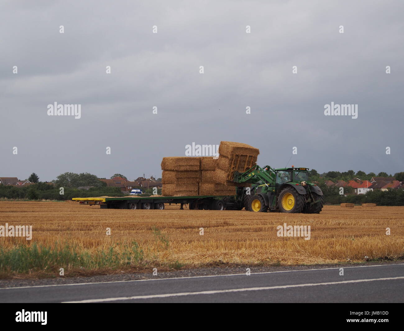 Cattedrale sul mare, Kent, Regno Unito. 27 Luglio, 2017. Regno Unito Meteo. Trattori fieno di carico prima della tempesta. Credito: James Bell/Alamy Live News Foto Stock