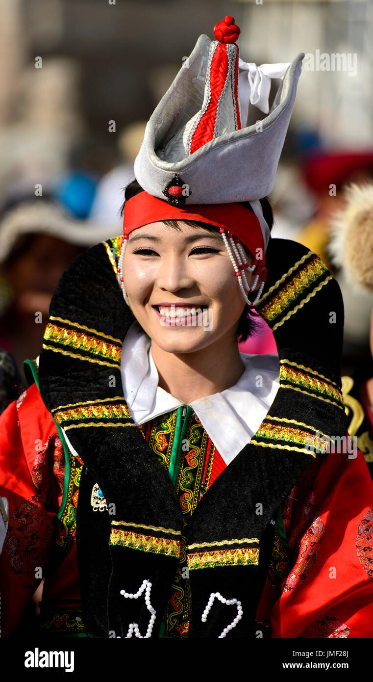 Giovane donna nel tradizionale costume deel e il tipico cappello con la parte superiore a forma di cono, mongola costume nazionale Festival, Ulaanbaatar, in Mongolia Foto Stock