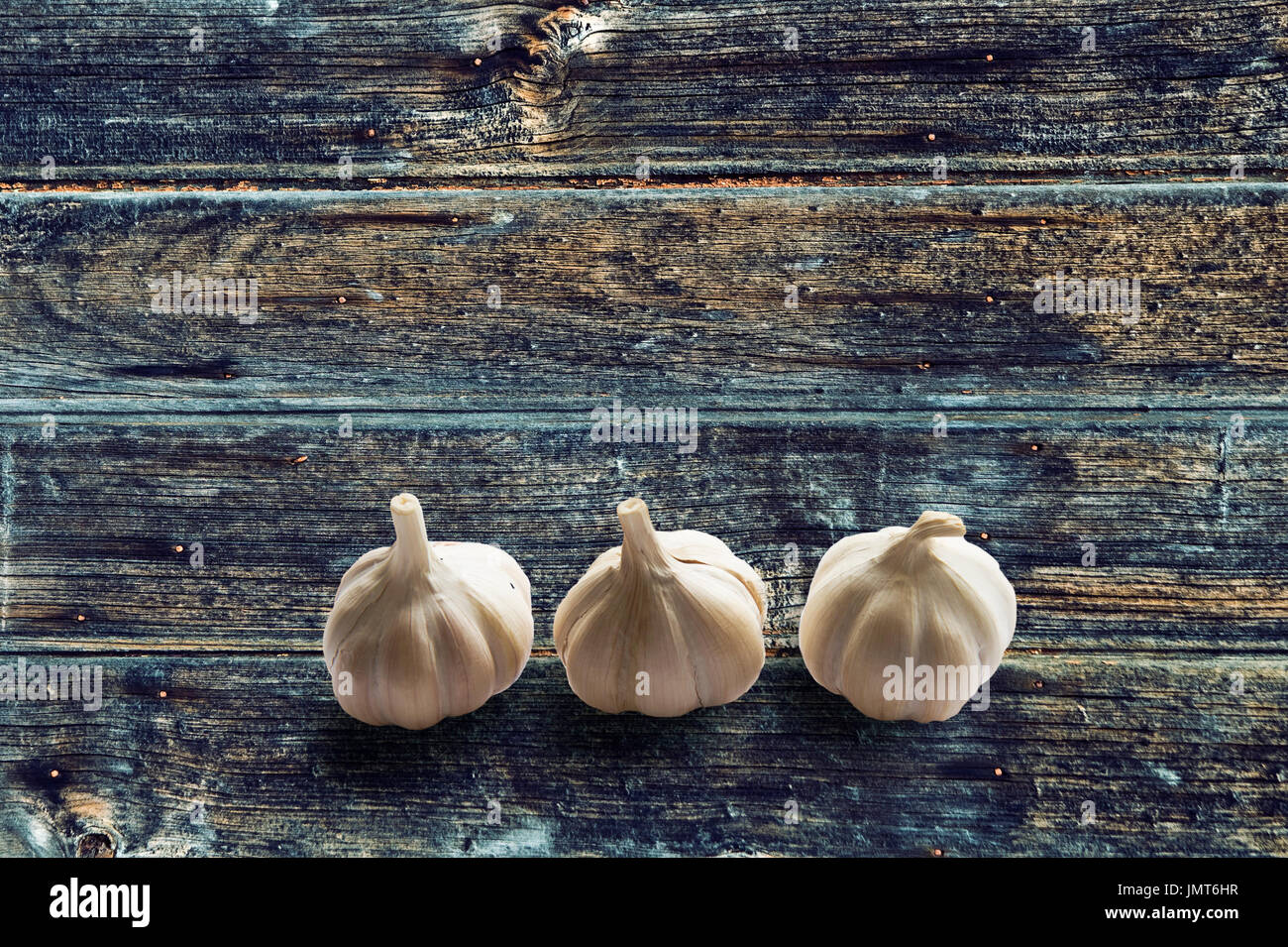 Aglio su vintage blu marrone legno colore sfondo texture Foto Stock