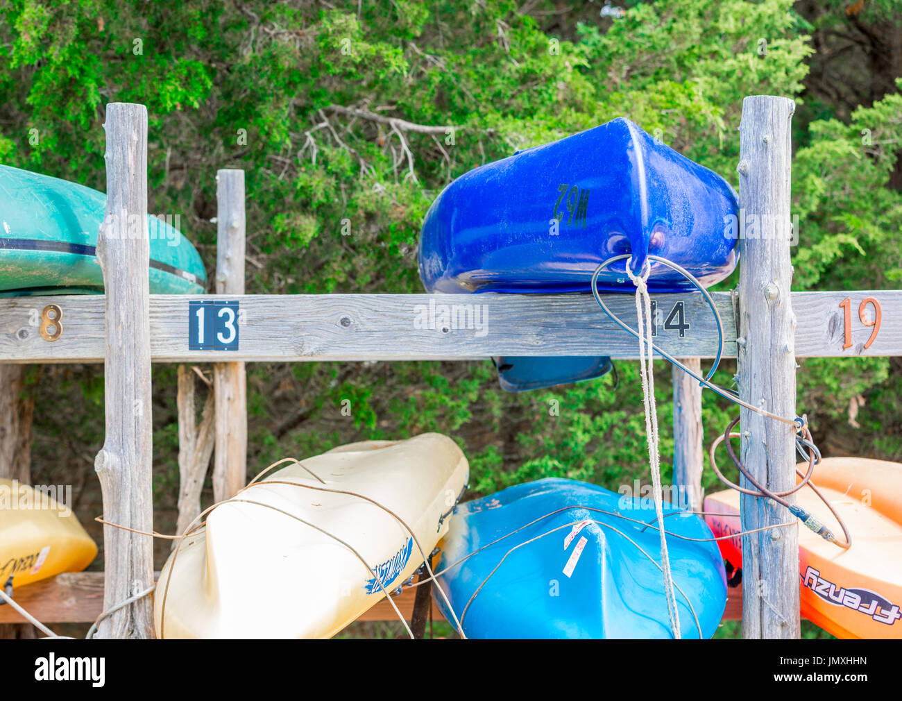 Colori vari kayak su un rack di legno in acqua chiara spiaggia di East Hampton, NY Foto Stock