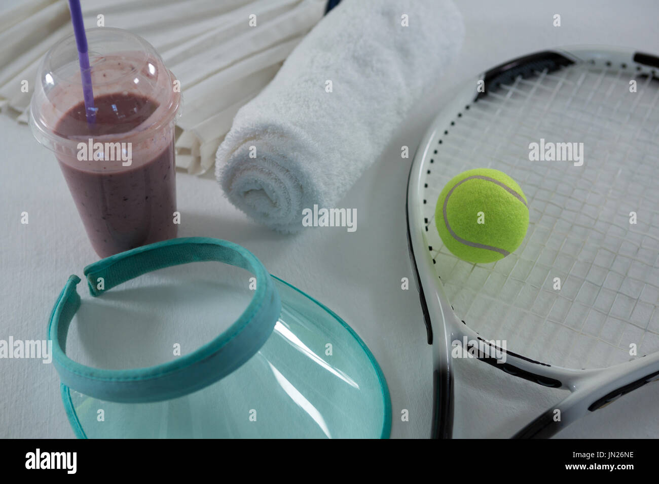 Alta vista angolare di racchetta con visiera parasole da bere e tovagliolo su sfondo bianco Foto Stock