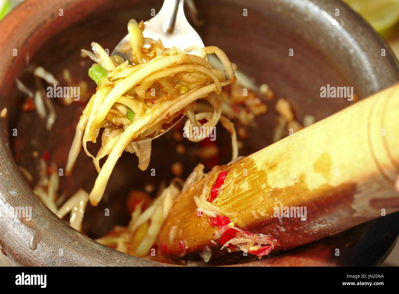 La cucina casalinga, piccante e aspro di verdure miste con insalata di papaya rotolo nella chiamata motar Som Tum in thai Foto Stock