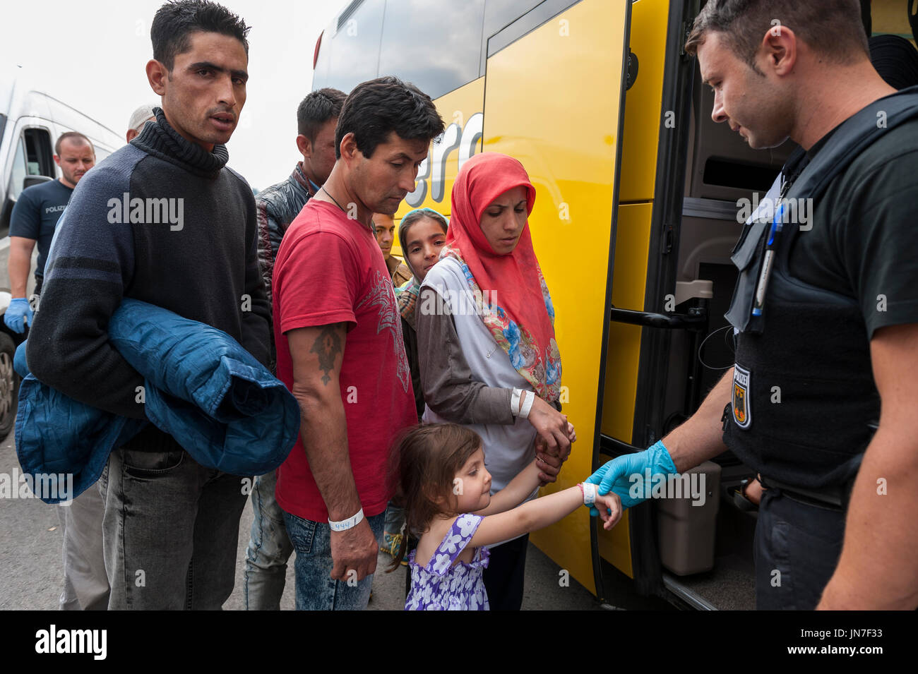 Passau, Germania - 2 Agosto 2015: rifugiato famiglia andare in un bus sulla strada da migranti centro di registrazione in Passau, Germania meridionale, Foto Stock