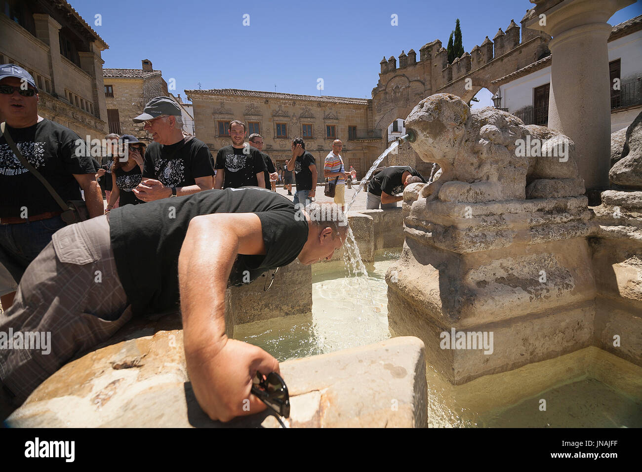 Uomo di mezza età il raffreddamento nella fontana gate di Jaen Baeza, la fontana dei leoni nella Plaza di populo (chiamato anche la piazza dei Leoni), Baeza, Spagna Foto Stock