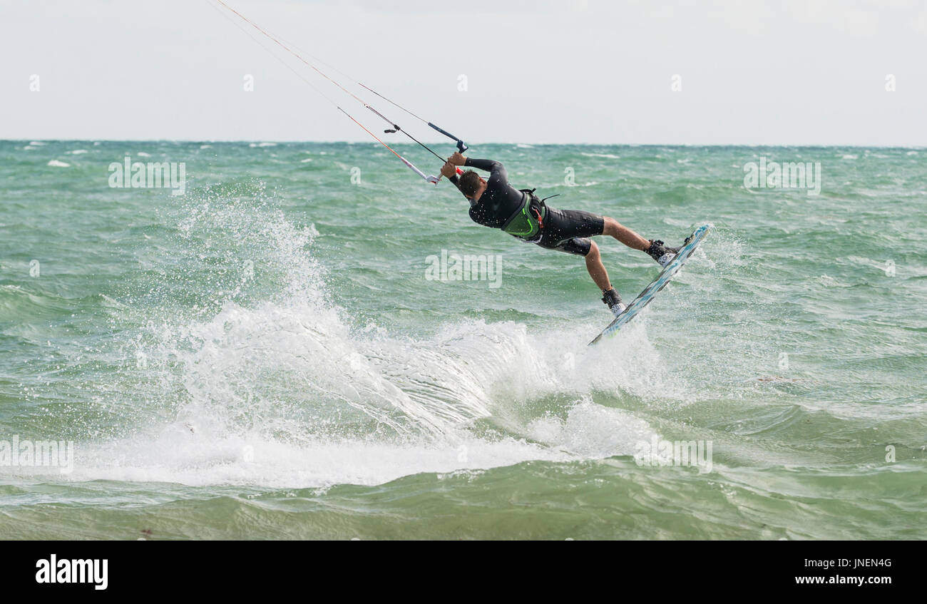 Uomo di Kitesurf in mare in forte vento. Foto Stock