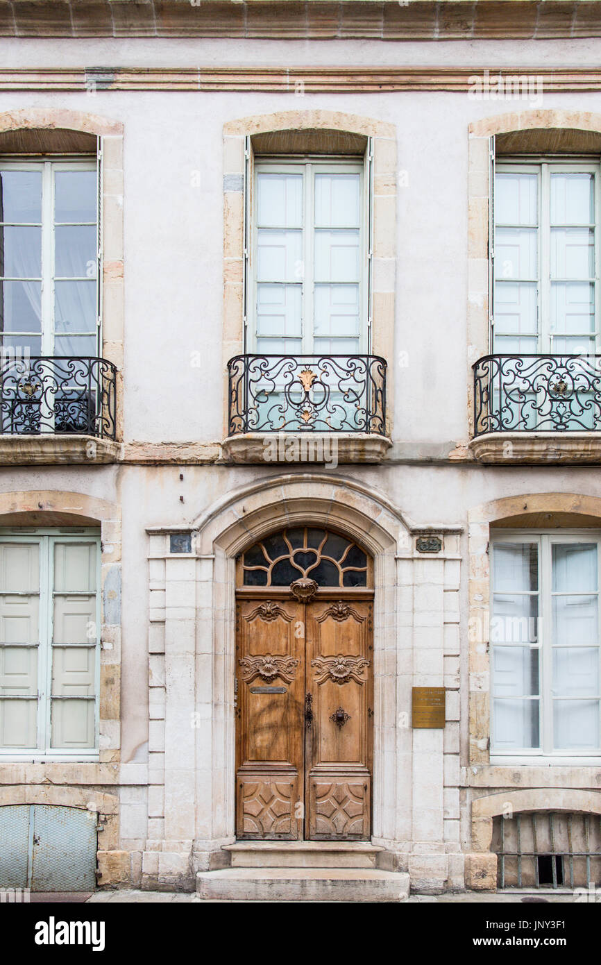 Beaune, Borgogna, Francia - 11 Ottobre 2015: Smart porta di legno, entrata di pietra e balconi in ferro battuto su un edificio di Beaune, Borgogna, Francia. Foto Stock