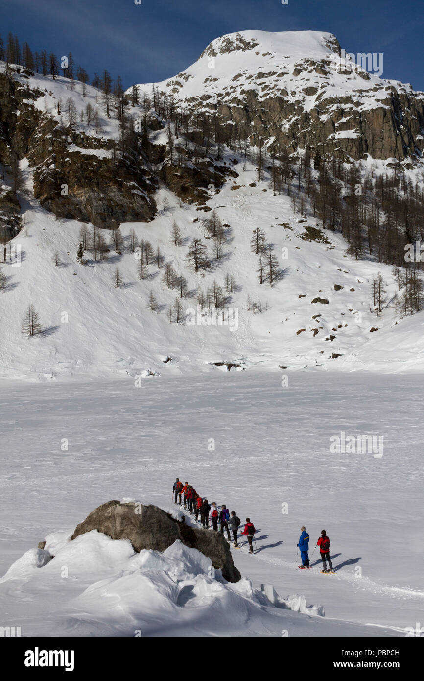 Escursioni con le racchette da neve sono a partire l'escursione sulla congelati Devero Lago, nel Parco Naturale dell'Alpe Devero,Piemonte, Italia Foto Stock