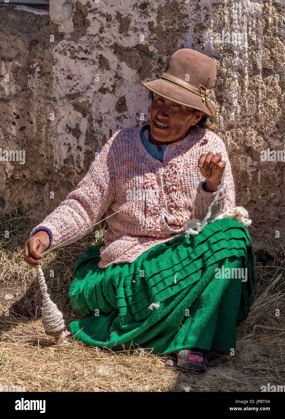 Ayamara donna in costume tipico lavora con un mandrino. Aymaras sono la popolazione autoctona del Lago Titicaca area, in Bolivia, Sud America. Foto Stock