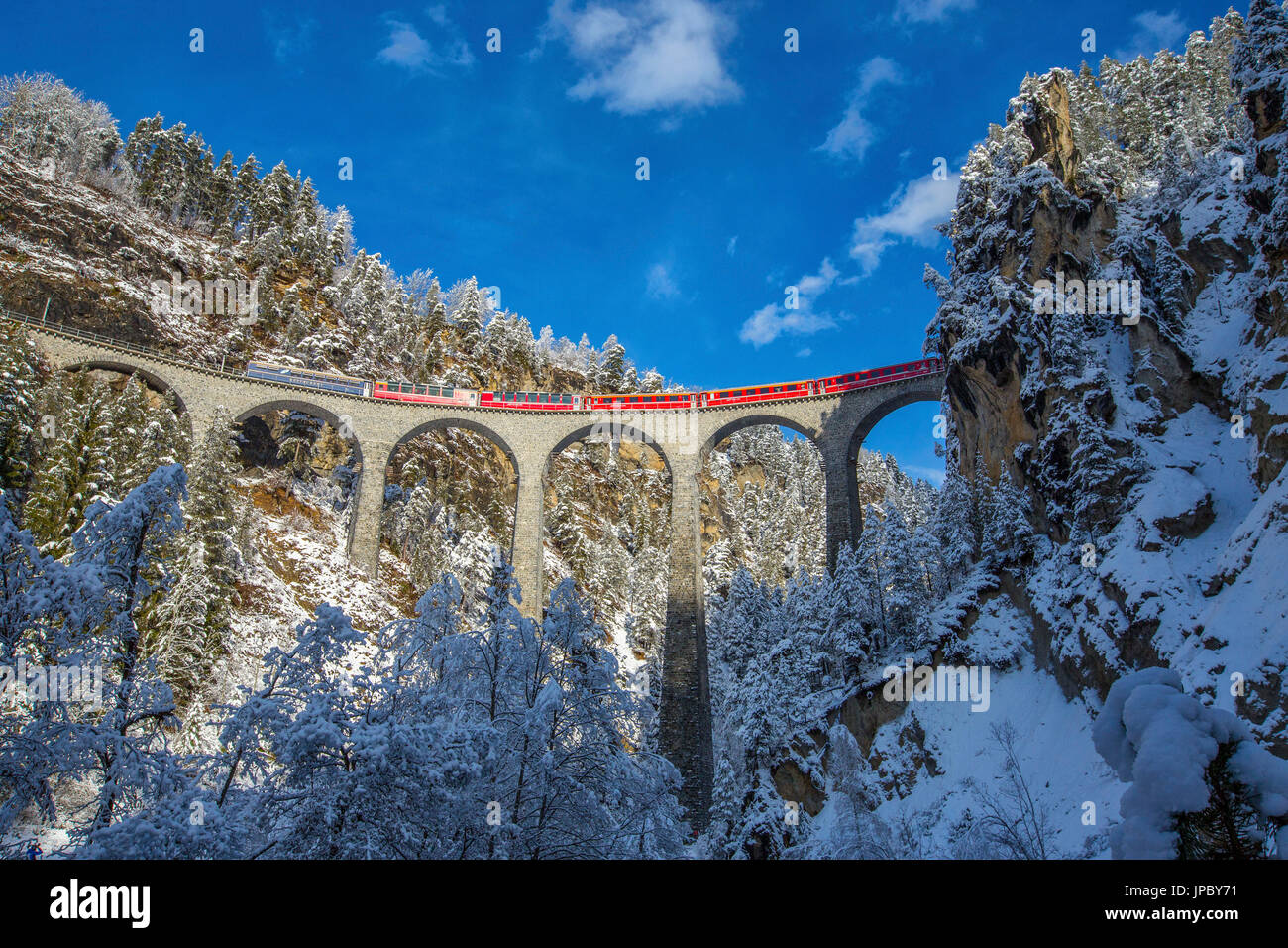 Bernina Express passa attraverso i boschi innevati Filisur Cantone dei Grigioni Svizzera Europa Foto Stock
