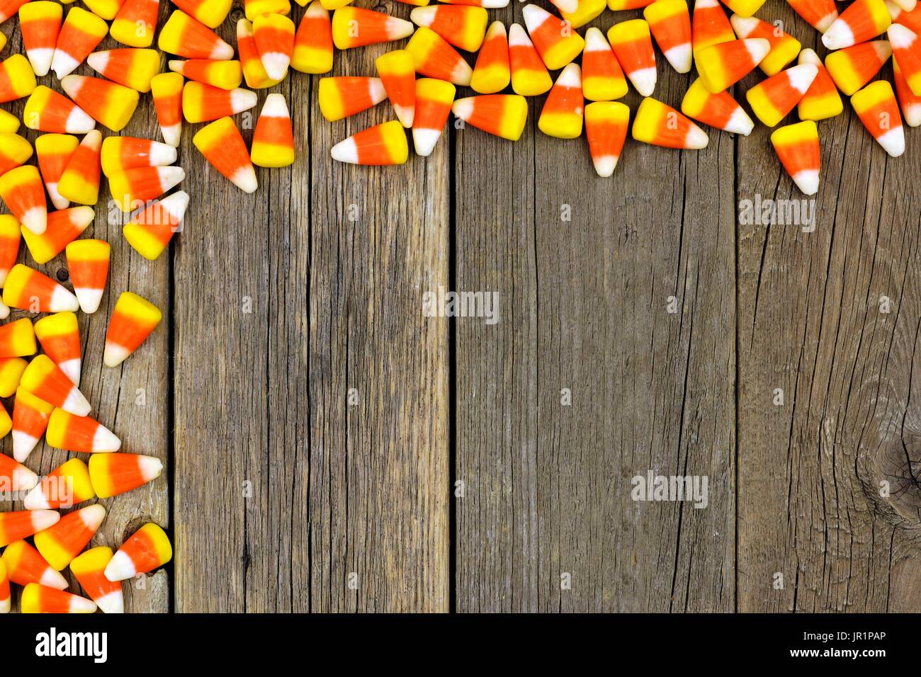 Halloween Candy corn alto angolo bordo contro un rustico sfondo legno Foto Stock
