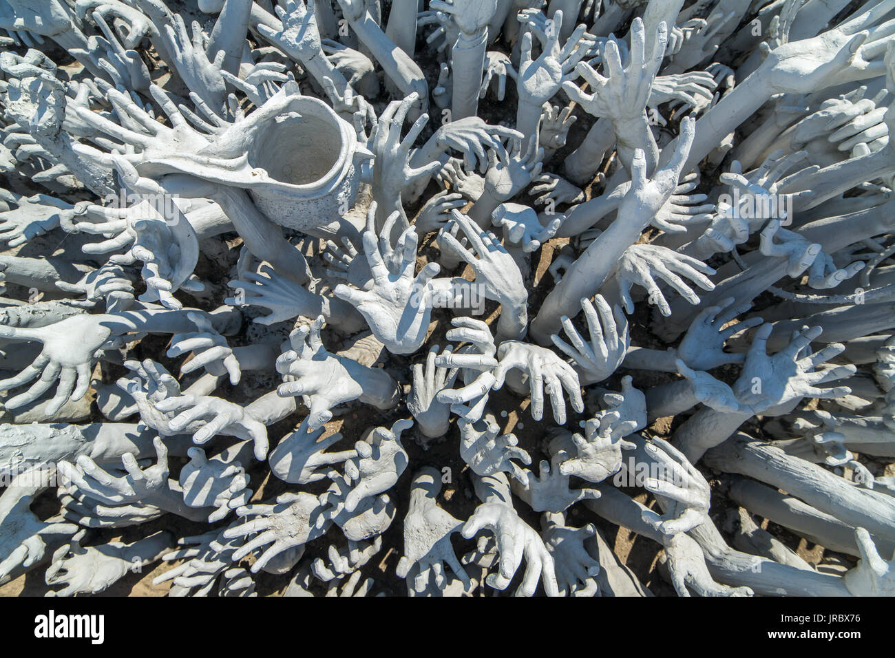 Dettaglio del famoso Wat Rong Khun (bianco tempio) nella provincia di Chiang Rai, la Thailandia del Nord. Le mani dall'inferno Foto Stock