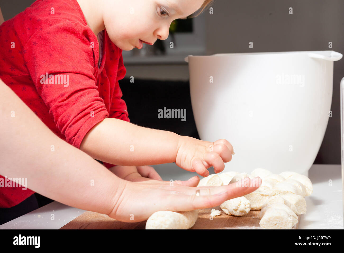 La madre e il bambino figlia ragazza sono la cucina in cucina. Cibo fatto in casa e little helper. Foto Stock