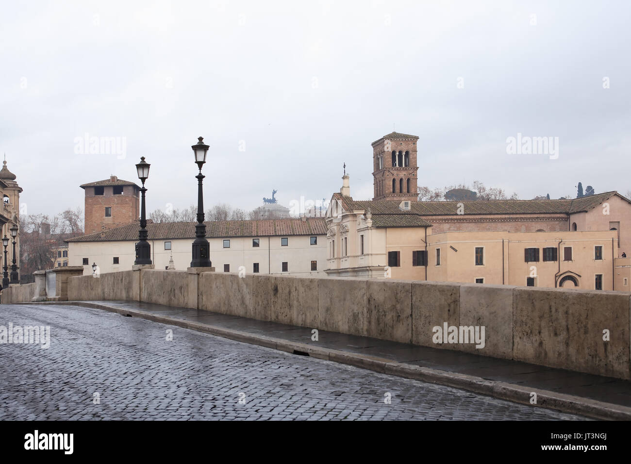Tranguil scena urbana. Un antico ponte in pietra con lampade di via Roma, Italia Foto Stock
