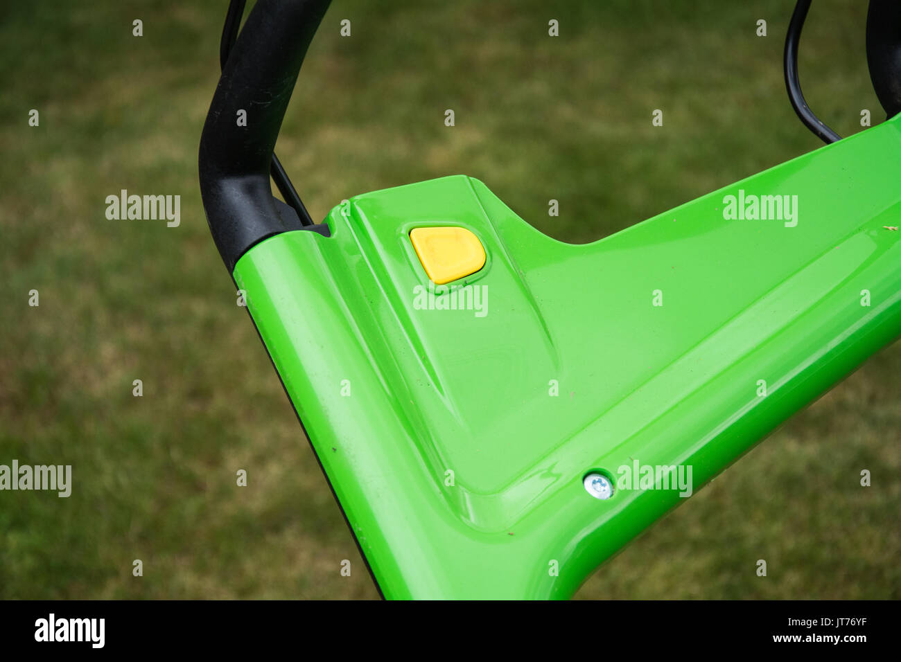 Il pulsante di accensione sul manubrio di un tosaerba cordless (VIKING MA339C). Estate, UK. Foto Stock