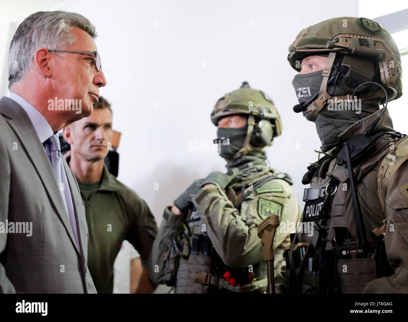 Berlino, Germania. 8 Ago, 2017. Ministro tedesco degli interni Thomas de Maiziere (CDU) in colloquio con i membri di una nuova élite unità di polizia a Berlino, Germania, 8 agosto 2017. Il gruppo è stato istituito per gestire estremamente complesse operazioni come l'anti-operazioni di terrore. Il gruppo comprende i membri di un certo numero di differenti elite tactical unità compreso il Grenzschutzgruppe 9 (GSG 9; inglese: la protezione alle frontiere Gruppo 9). Foto: Kay Nietfeld/dpa/Alamy Live News Foto Stock