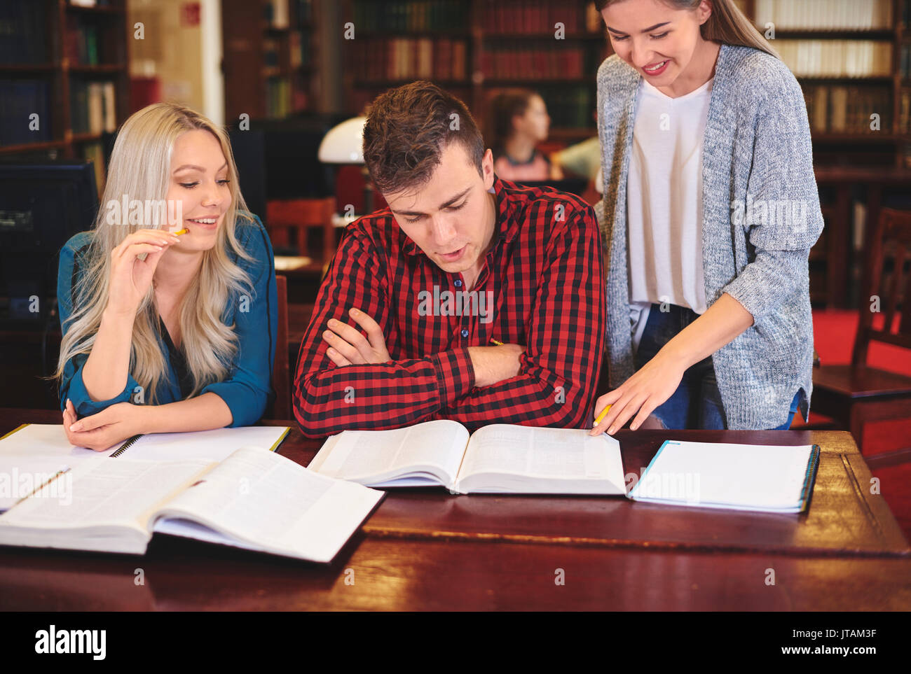 Gli studenti che studiano per esame in biblioteca Foto Stock