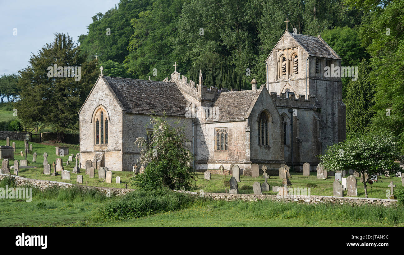 Un tipico paese di lingua inglese in scena con la vecchia chiesa del paese impostato nel cimitero circondato da campi e alberi Foto Stock