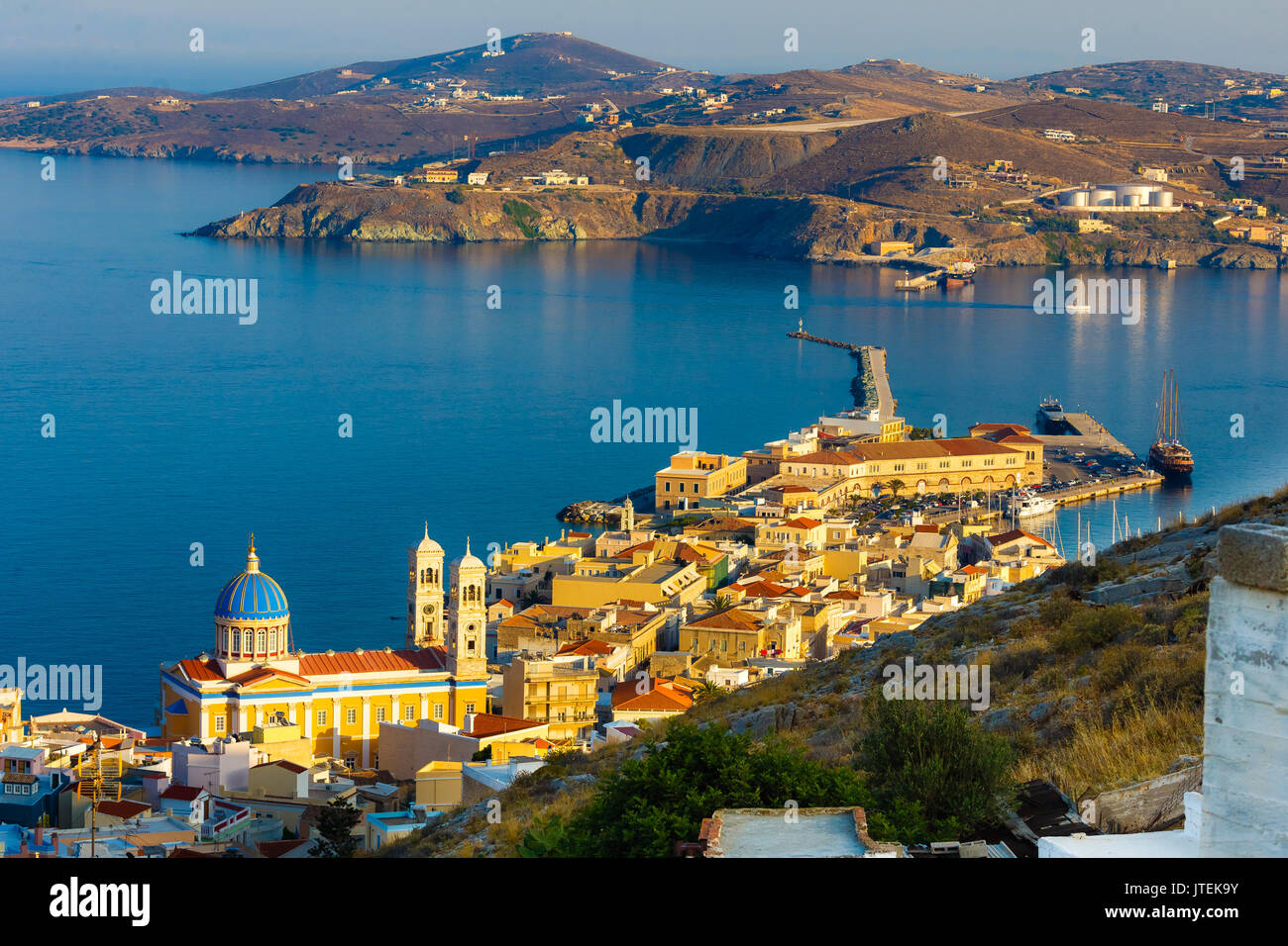 Ermoupolis o porta Hermoupolis e edifici di distanza al crepuscolo.Ermoupolis è una città e ex comune sull'isola di Syros, Cicladi Grecia Foto Stock