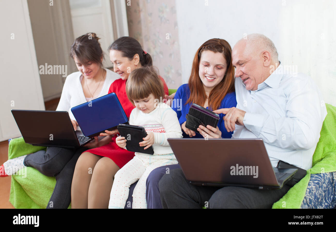 Felice famiglia multigenerazionali utilizzando pochi laptop in casa Foto Stock