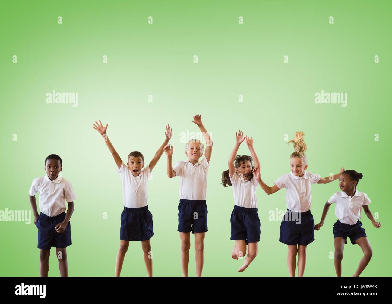 Composito Digitale dei bambini multiculturale jumping davanti a uno sfondo verde Foto Stock