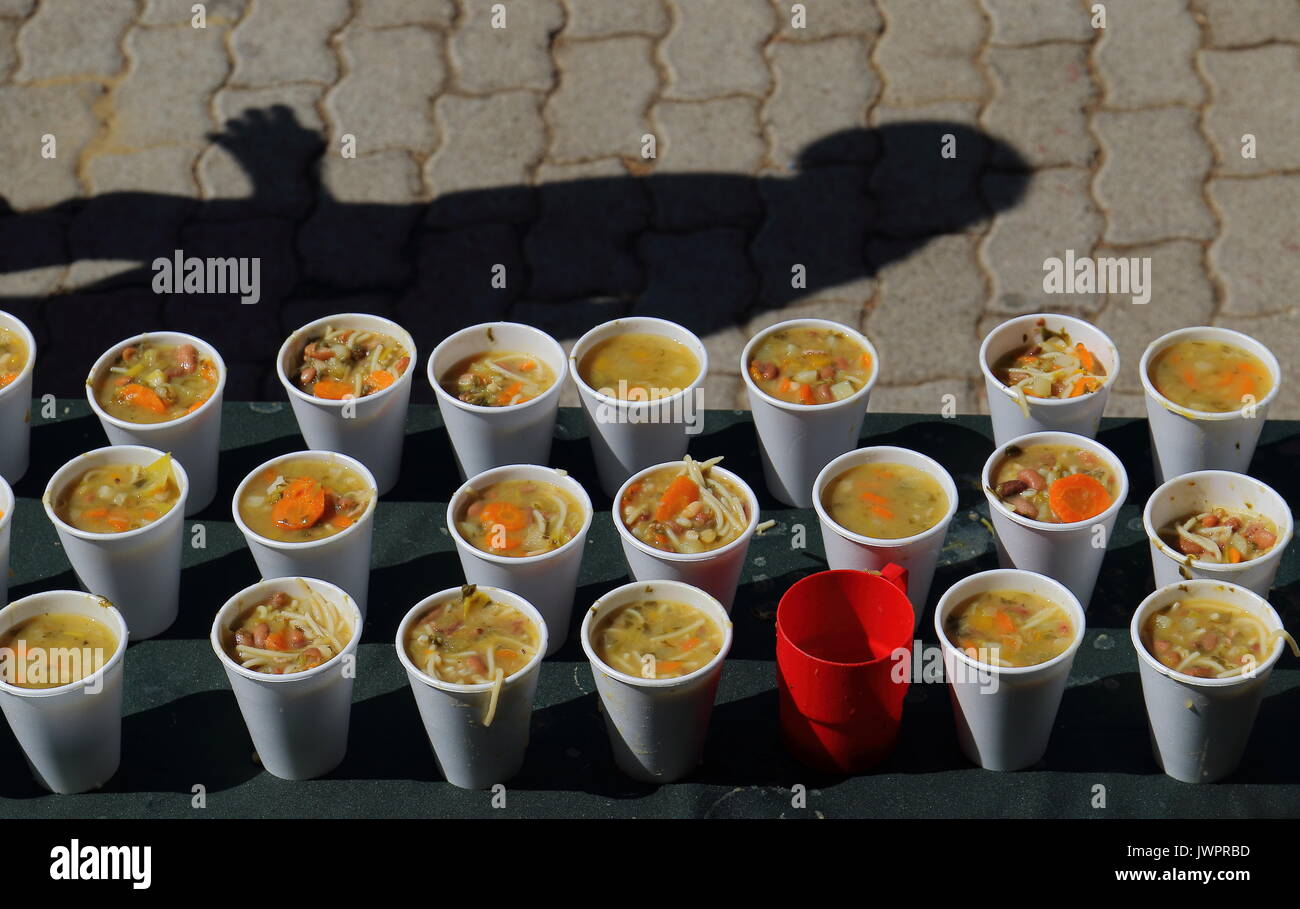 Tazze di zuppa di verdure in una mensa per i diseredati formato orizzontale con spazio di copia Foto Stock