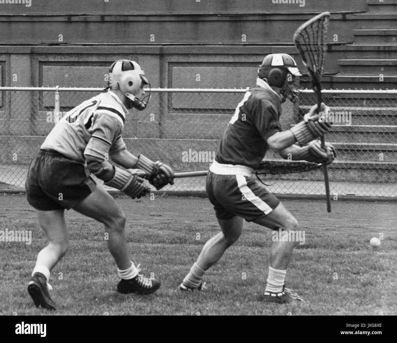 Lacrosse Azione girato prese durante un gioco non identificato, un lettore Hopkins e un membro della squadra avversaria entrambi cercano di prelevare la palla da terra, 1950. Foto Stock