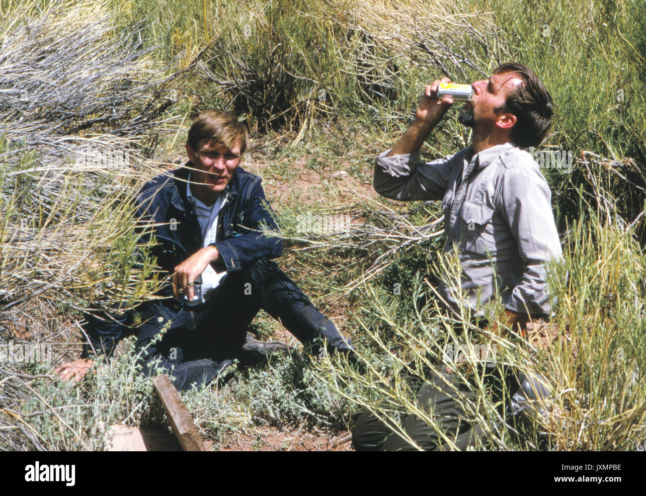 Edward Abbey e scrittore Daniel Chapman bere bevande fredde a partire da un terreno frigorifero nel deserto presso il Parco Nazionale di Canyonlands nel 1969. Foto Stock