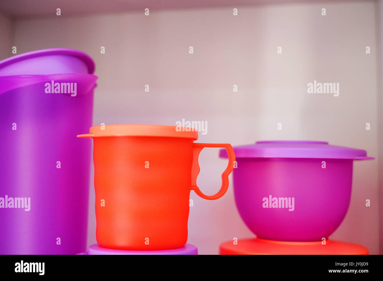 Colorate di stoviglie di plastica tazza e brocca sul ripiano Foto Stock