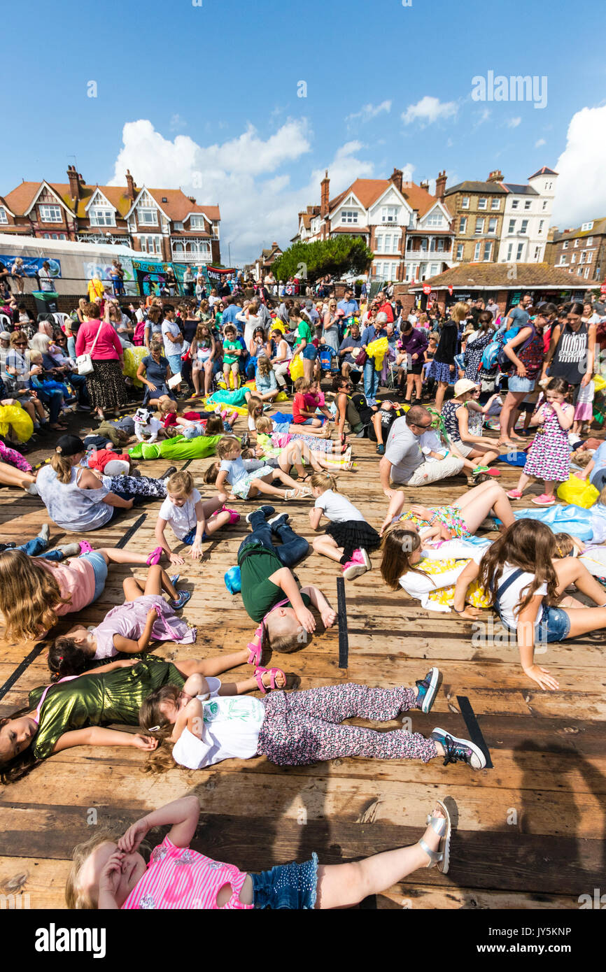Terrazza esterna coperta in bambini che finge di essere in stato di stop durante il gioco durante l'Hobby Horse Club incontro a Broadstairs Settimana della musica folk. Sole, cielo blu. Foto Stock